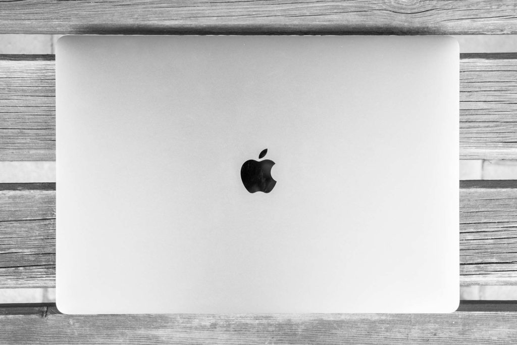 Closed Apple laptop from top with Apple logo showing