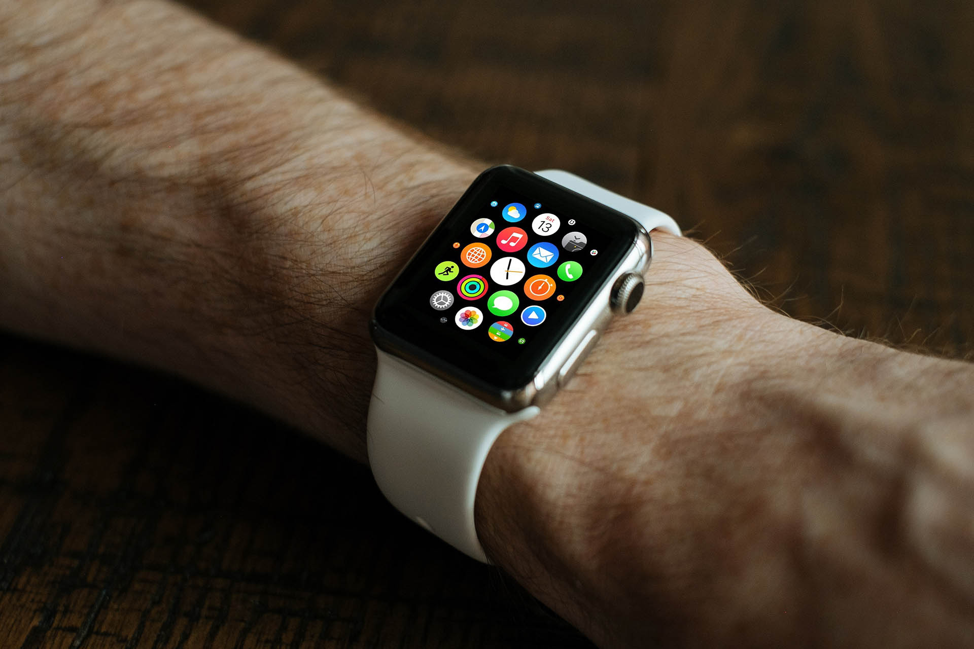 Silver Apple Watch with white Sport Band and honeycomb menuon arm