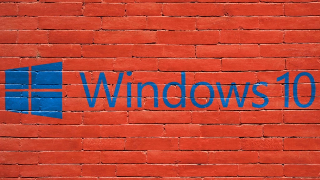 Red brick wall with Windows 10 and Windows 10 logo painted in blue
