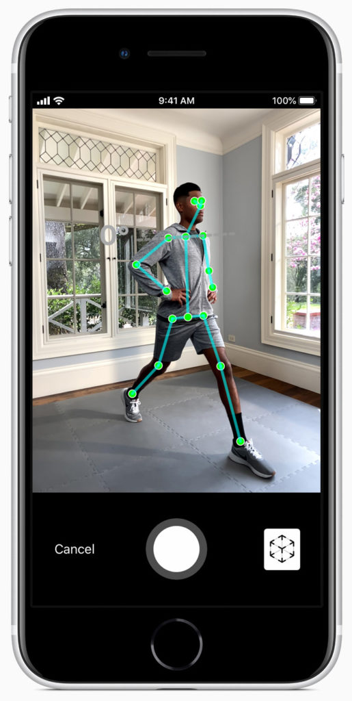 iPhone S E screen showing man in a stretch position with green lines drawn on his body using augmented reality to capture and analyse his movements